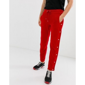 ASOS DESIGN skinny joggers with side poppers and piping in red velour