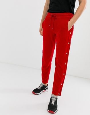 ASOS DESIGN skinny joggers with side poppers and piping in red velour