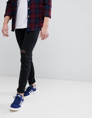 ASOS DESIGN skinny jeans in black with knee rips