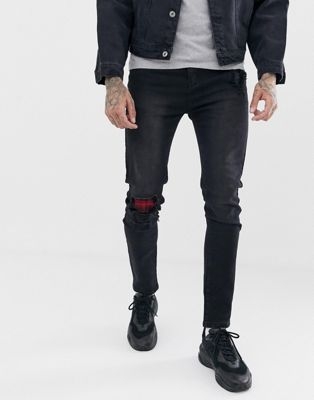 Liquor N Poker skinny jeans in washed black with abrasion check patches