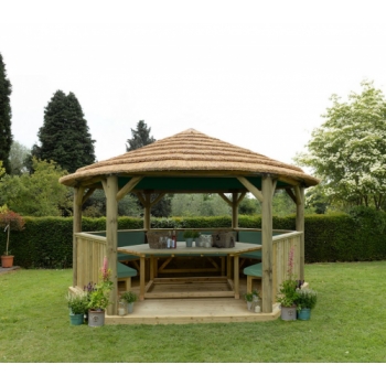 Forest Garden 4.7m Hexagonal Wooden Garden Gazebo with Thatched Roof - Furnished with Table, Benches and Cushions (Green)